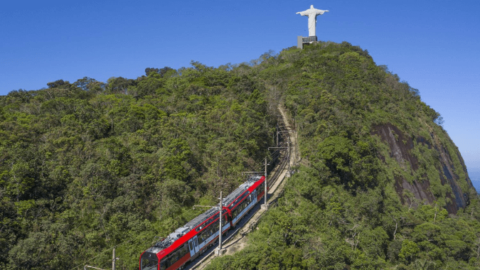 Travel by train through the Tijuca Forest while ascending the Corvocado Mountain